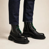 Black side-zip lug sole boots with denim on-foot studio photo