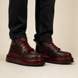 Burgundy crocodile platform boots on-foot studio photo