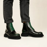 Green-black polished lace-up boots on-foot studio photo